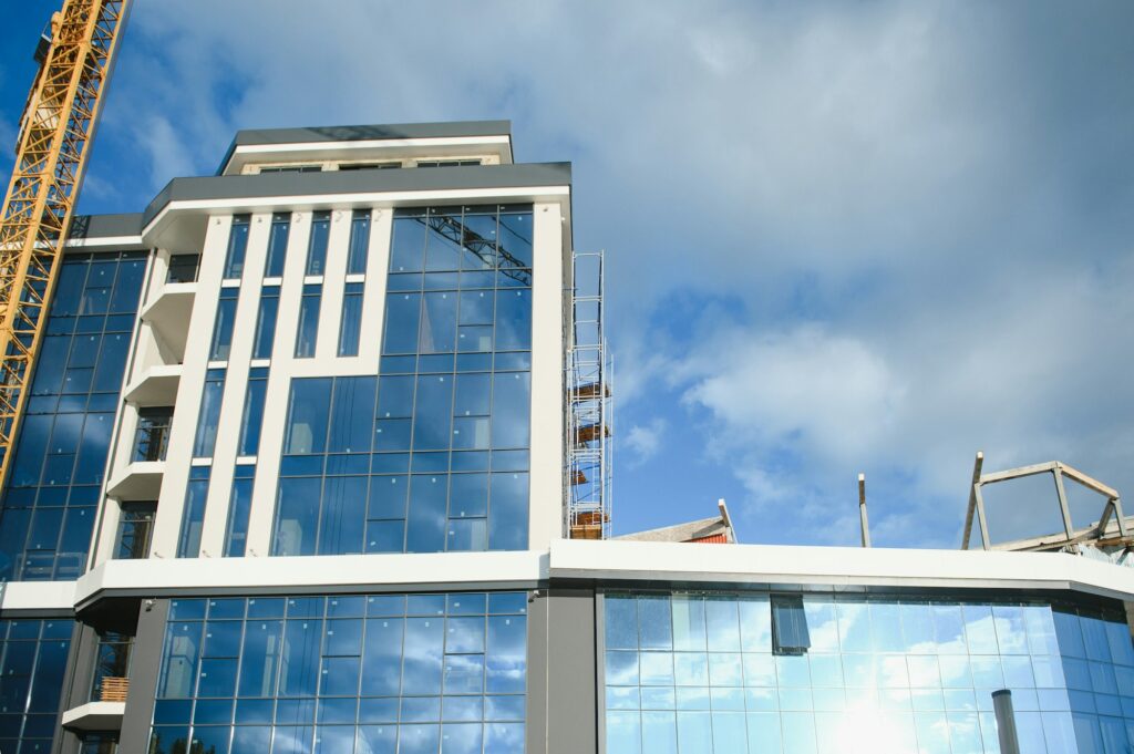 Modern building under construction against blue sky